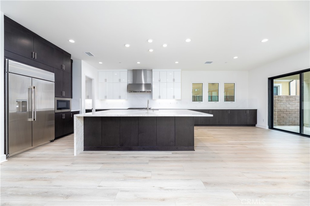 108 Coldwater Irvine, CA 92602 - Photo 28 of 36 a large kitchen with stainless steel appliances kitchen island granite countertop a large counter top and a stove top oven