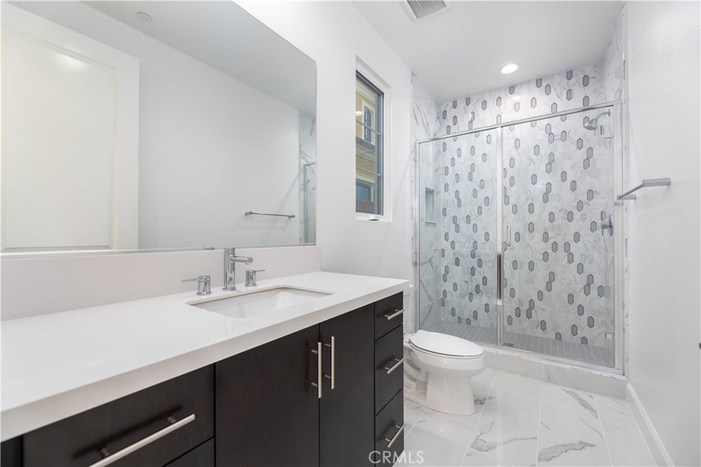 108 Coldwater Irvine, CA 92602 - Photo 5 of 36 a bathroom with a sink a toilet a mirror and shower