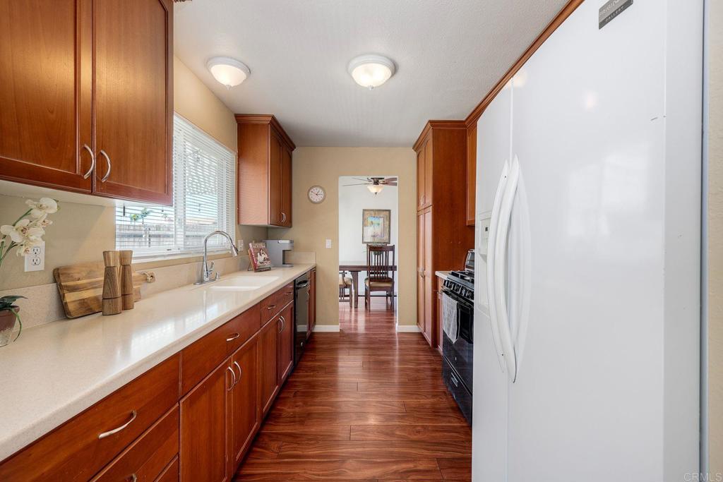 1114 Red Hawk Way San Marcos, CA 92078 - Photo 17 of 59 a kitchen with stainless steel appliances granite countertop lots of counter top space and wooden floor