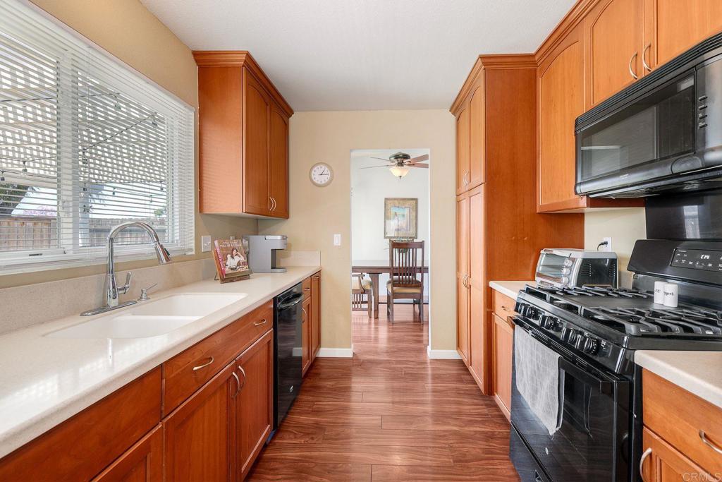 1114 Red Hawk Way San Marcos, CA 92078 - Photo 18 of 59 a kitchen with stainless steel appliances granite countertop a stove a sink and a microwave