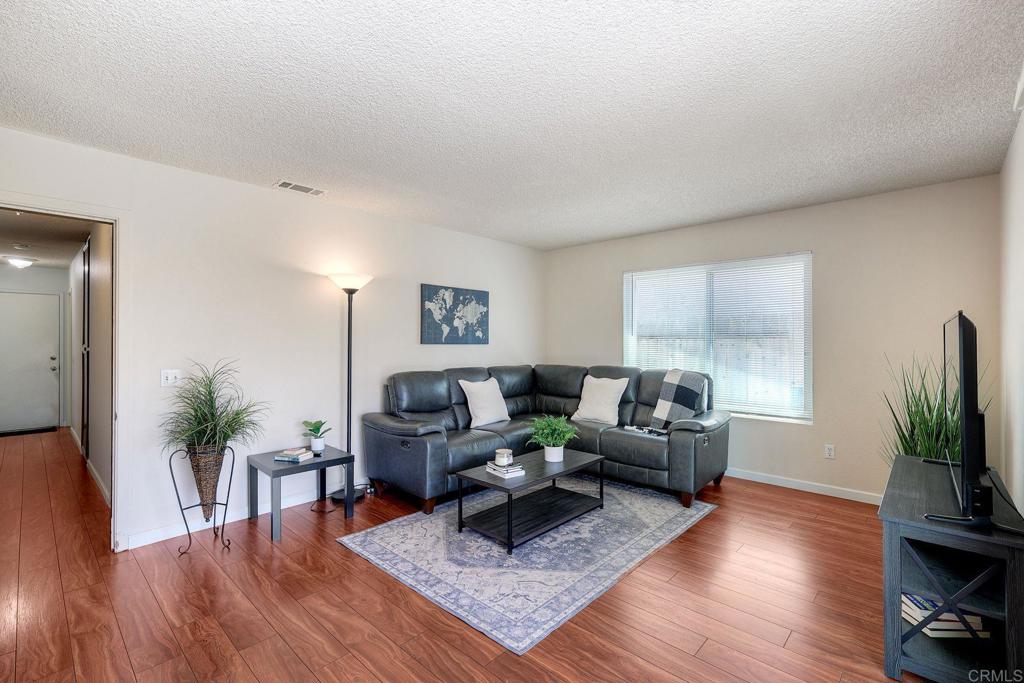 1114 Red Hawk Way San Marcos, CA 92078 - Photo 21 of 59 a living room with furniture potted plant and a flat screen tv