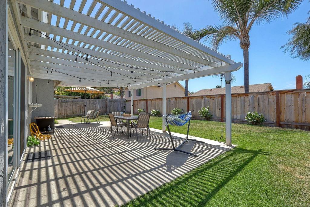 1114 Red Hawk Way San Marcos, CA 92078 - Photo 31 of 59 a view of a patio with table and chairs with wooden floor and fence