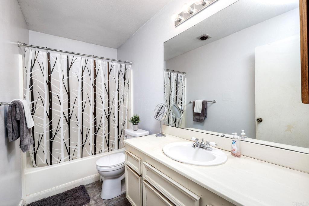 1114 Red Hawk Way San Marcos, CA 92078 - Photo 40 of 59 a bathroom with a toilet a sink and a mirror