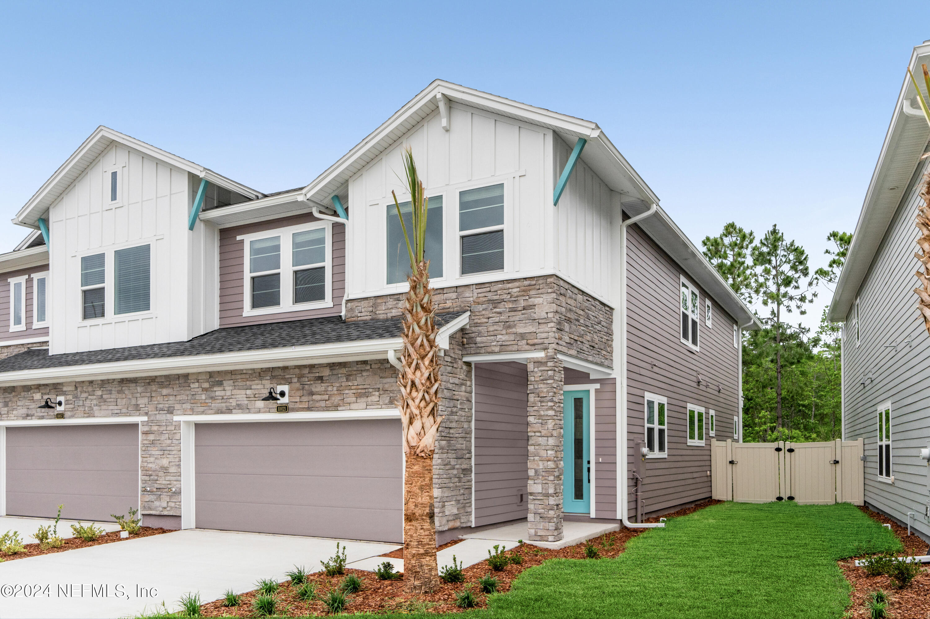 10021 Element Road Jacksonville, FL 32256 - Photo 1 of 18 a front view of a house with a yard and garage