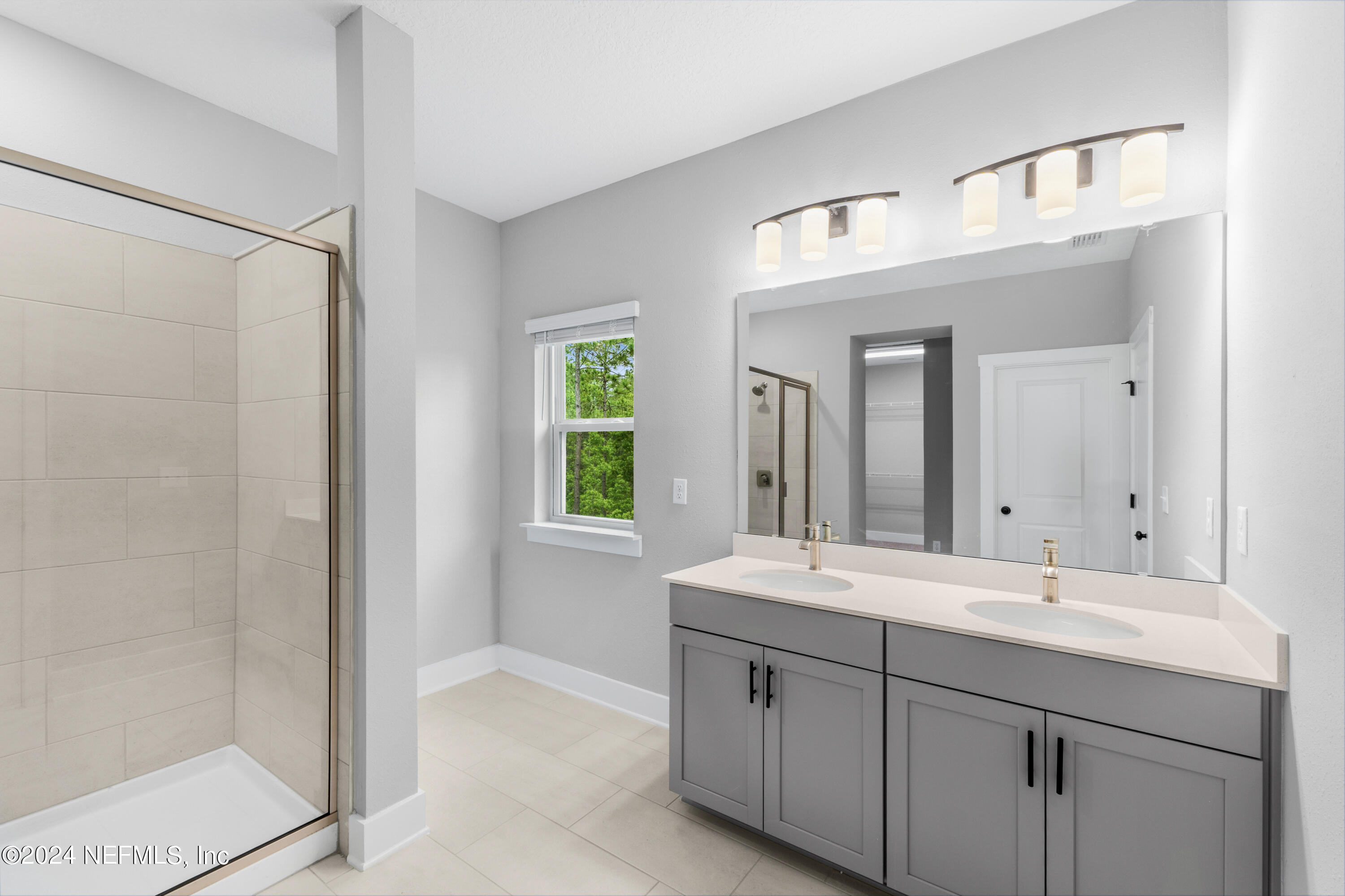 10021 Element Road Jacksonville, FL 32256 - Photo 17 of 18 a bathroom with a double vanity sink and a mirror