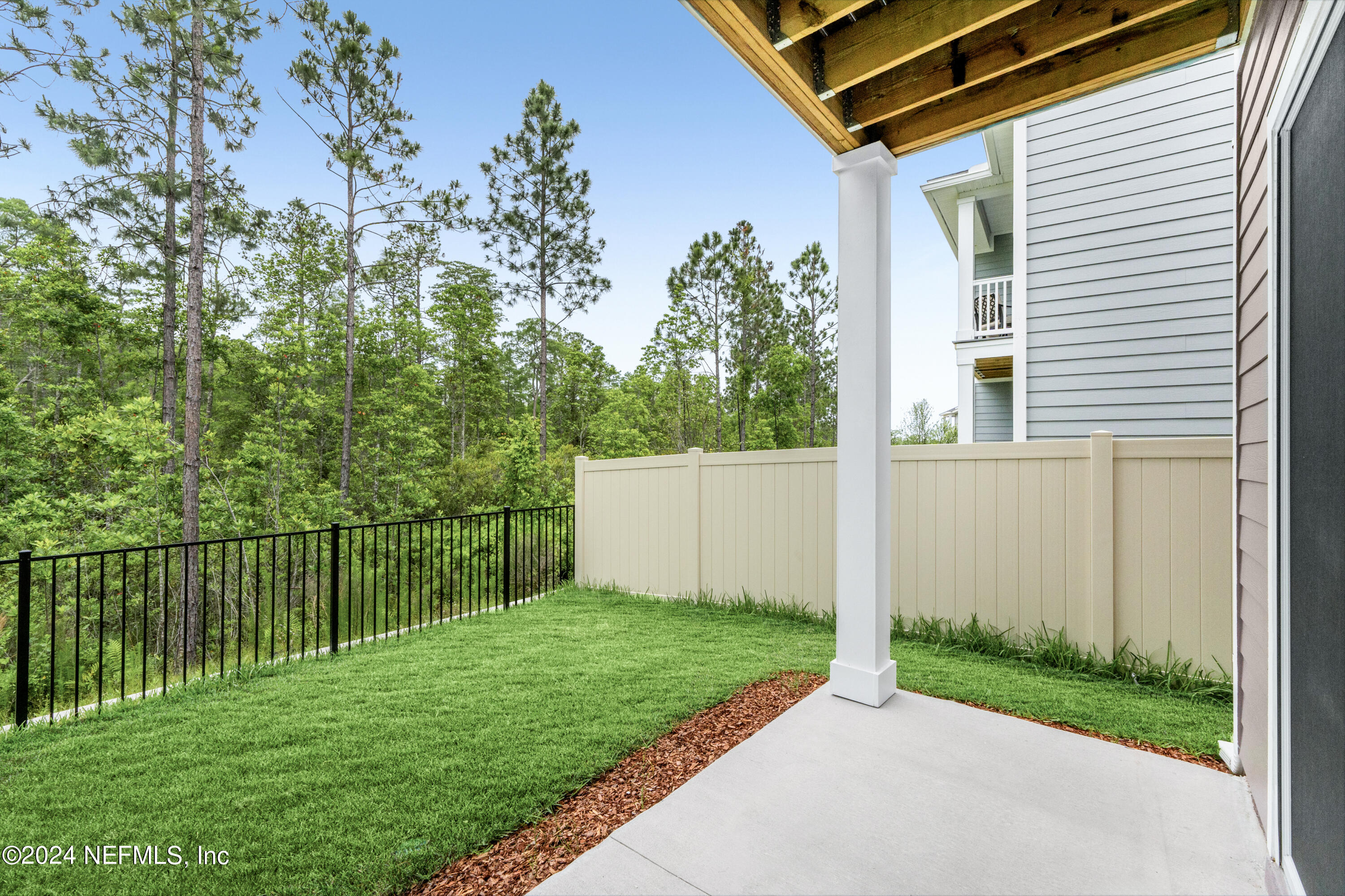 10021 Element Road Jacksonville, FL 32256 - Photo 18 of 18 a view of a backyard with potted plants and a large tree