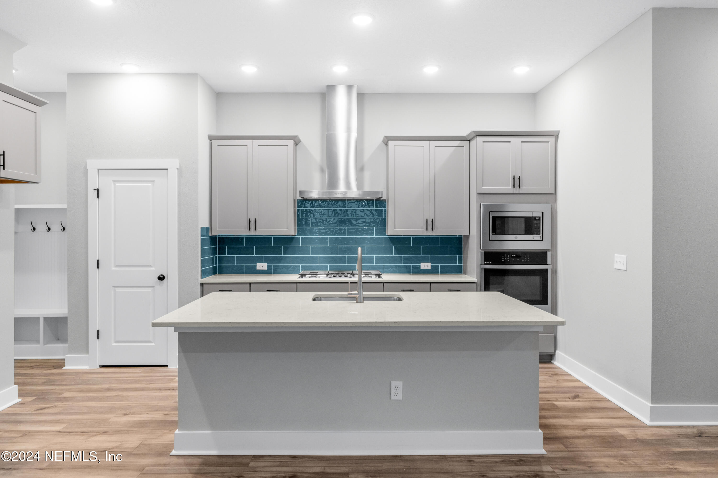 10021 Element Road Jacksonville, FL 32256 - Photo 3 of 18 a view of a kitchen with stainless steel appliances wooden floor and living room view