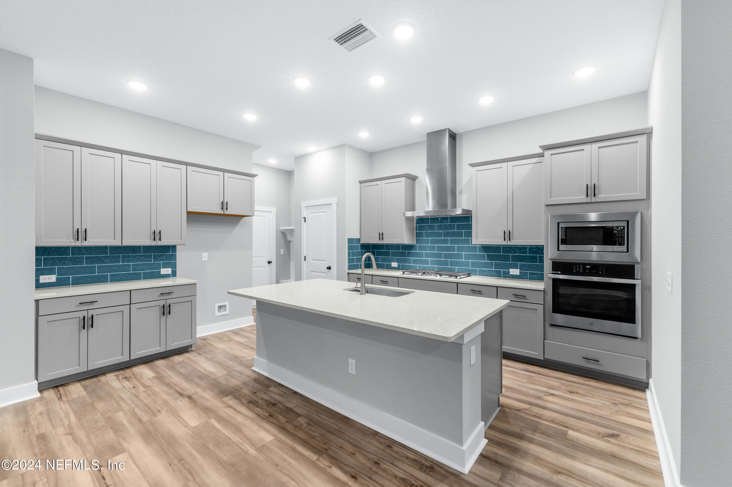10021 Element Road Jacksonville, FL 32256 - Photo 4 of 18 a large kitchen with kitchen island a sink stainless steel appliances and cabinets