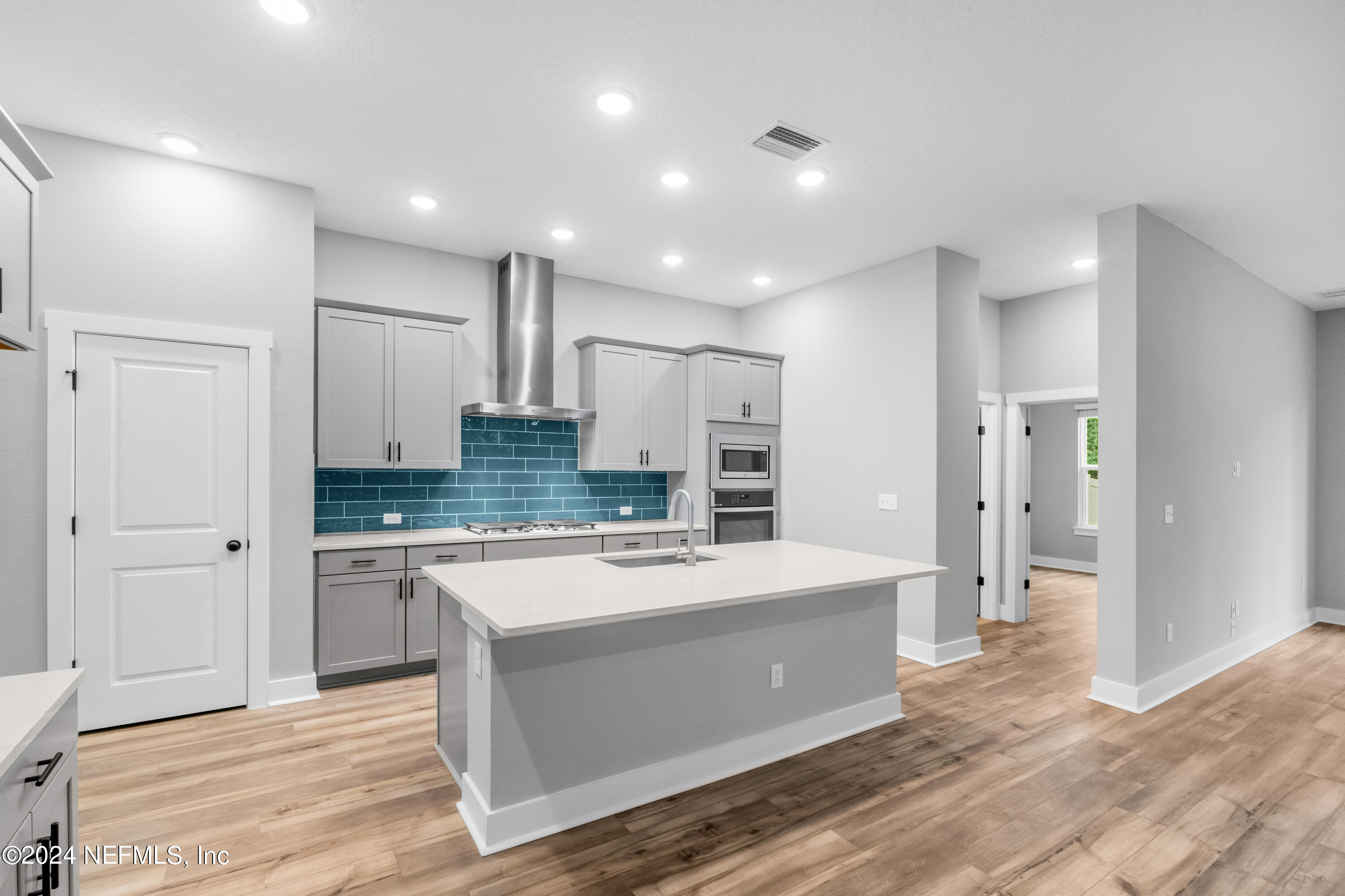 10021 Element Road Jacksonville, FL 32256 - Photo 9 of 18 a large kitchen with a refrigerator and a sink