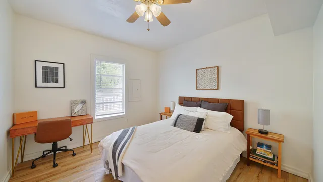 a bedroom with a bed and a chair