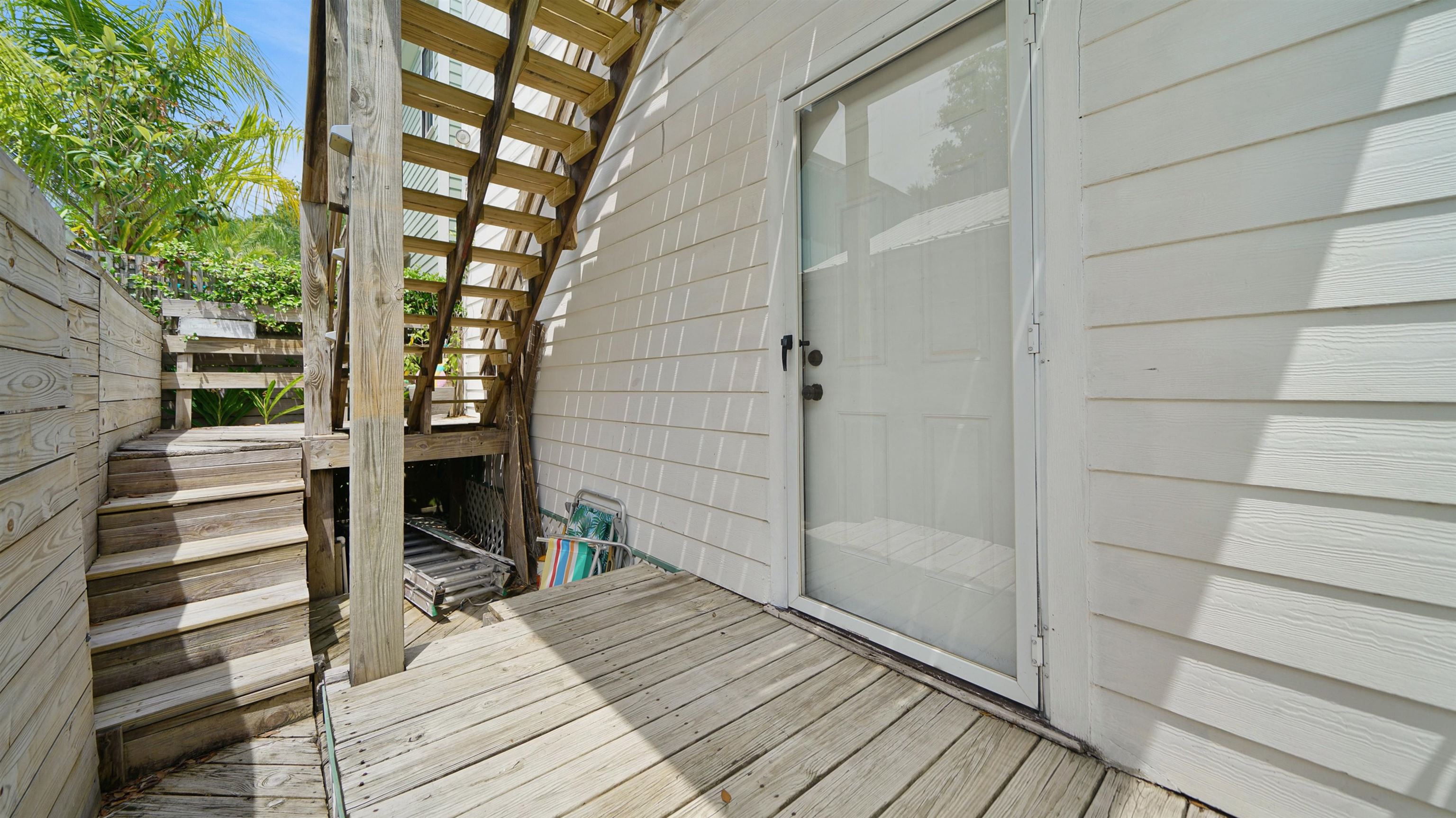 119 Moore Street St. Augustine, FL 32084 - Photo 19 of 49 a view of a balcony with wooden floor and iron stairs