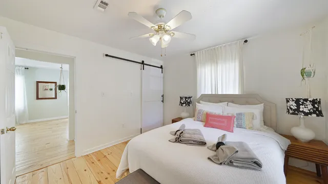 a bathroom with a sink toilet a mirror and window