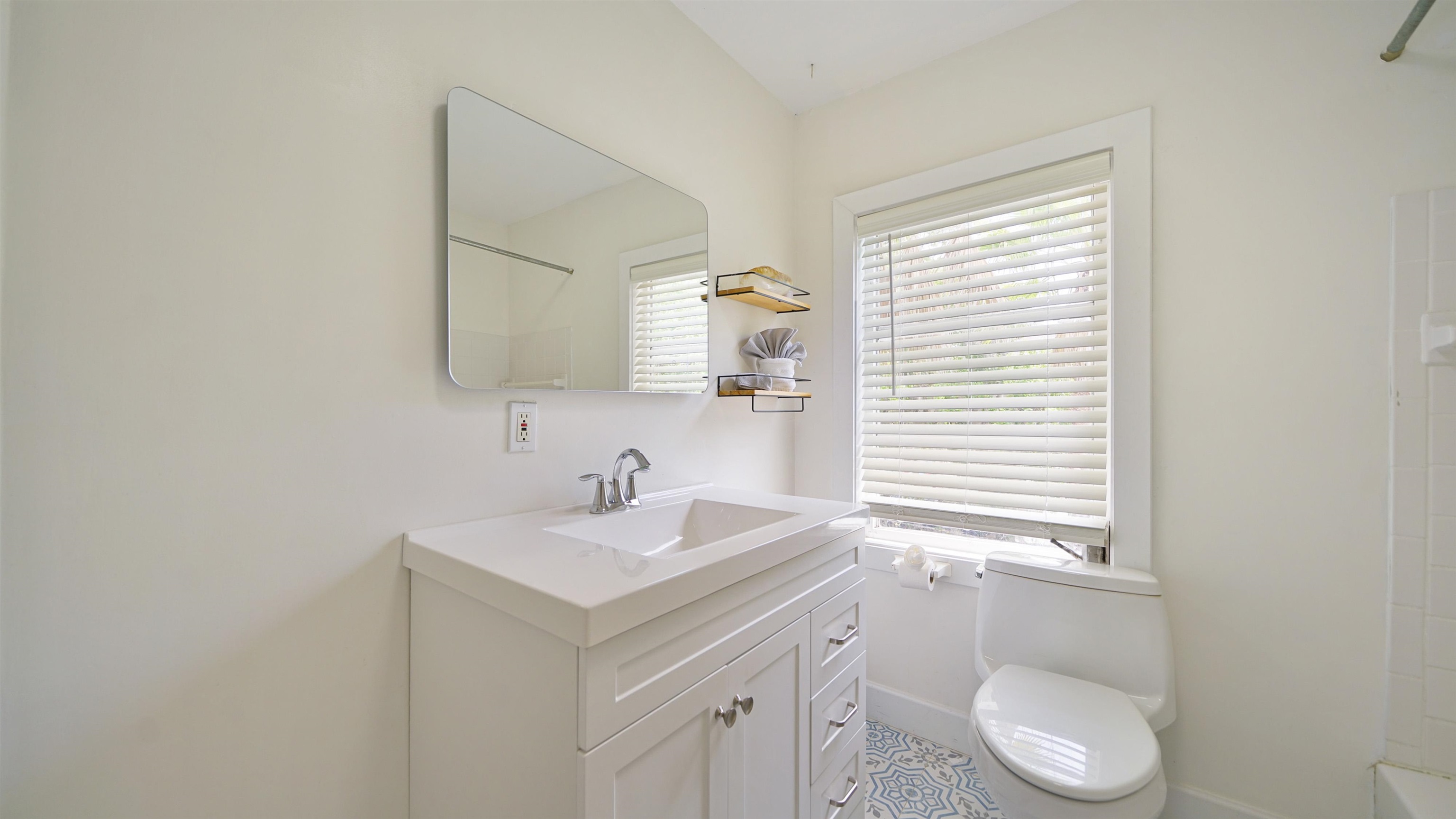 119 Moore Street St. Augustine, FL 32084 - Photo 30 of 49 a bathroom with a sink toilet a mirror and window