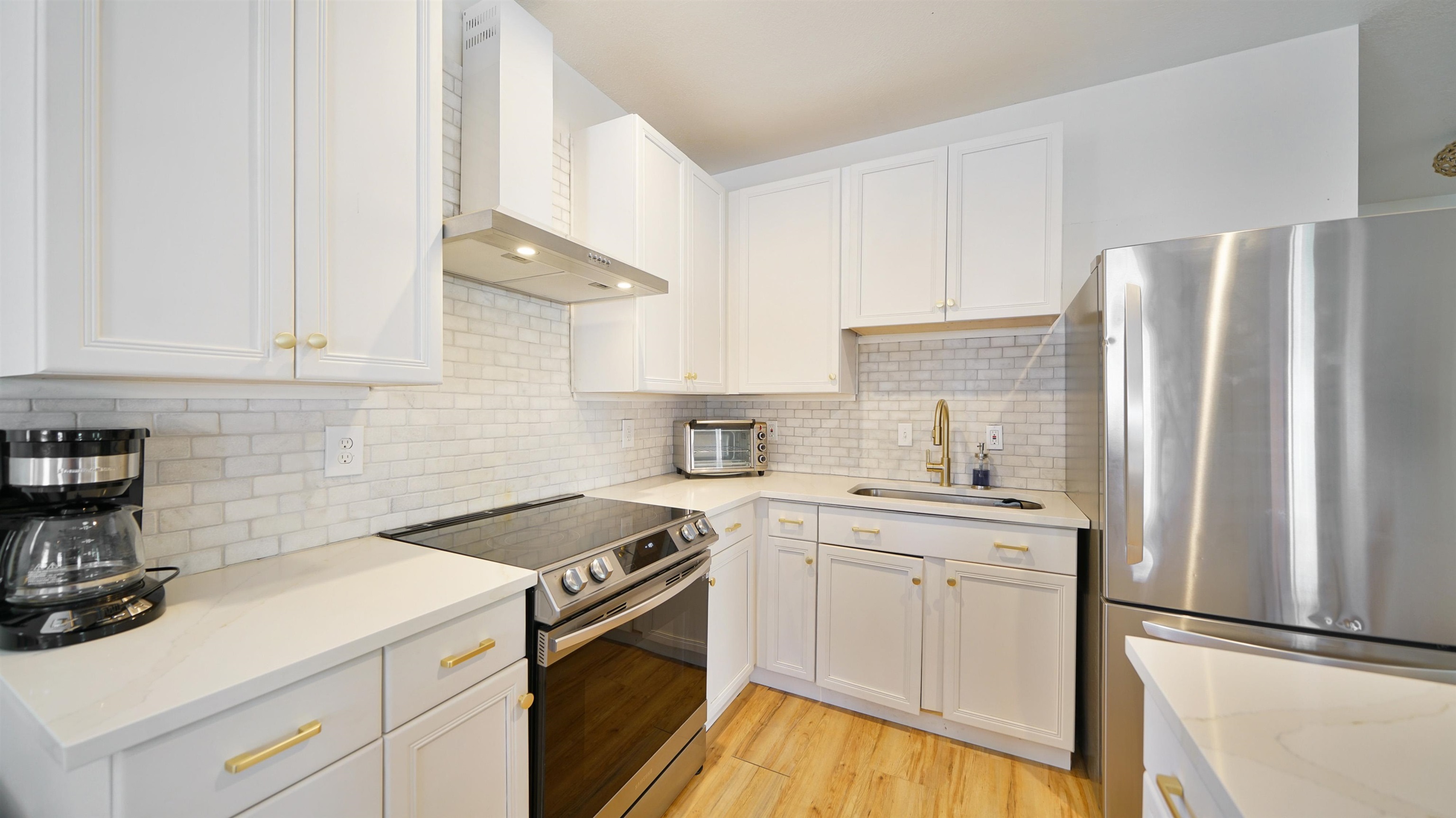 119 Moore Street St. Augustine, FL 32084 - Photo 10 of 49 a kitchen with stainless steel appliances granite countertop a sink stove and refrigerator