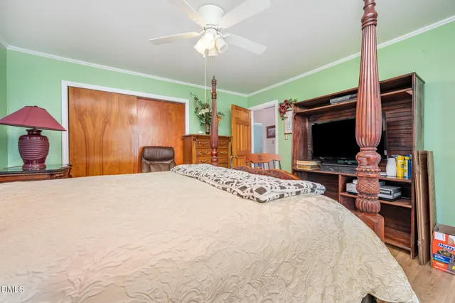 a bedroom with a bed and a flat screen tv