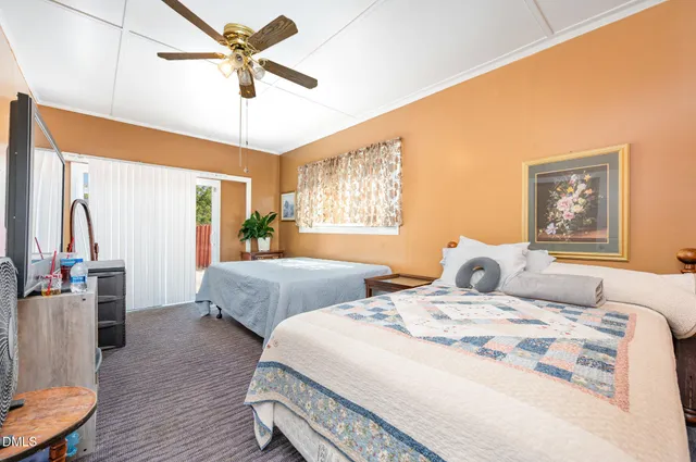 a bedroom with two beds and a large mirror