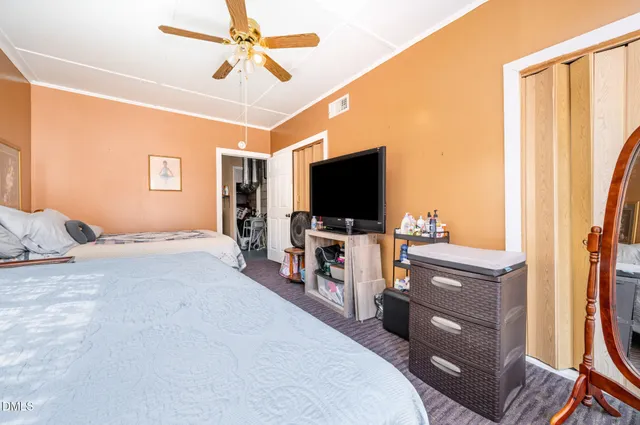 a bedroom with furniture and a flat screen tv