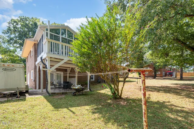 a backyard of a house with table and chairs