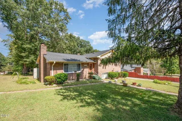 a front view of house with yard and trees