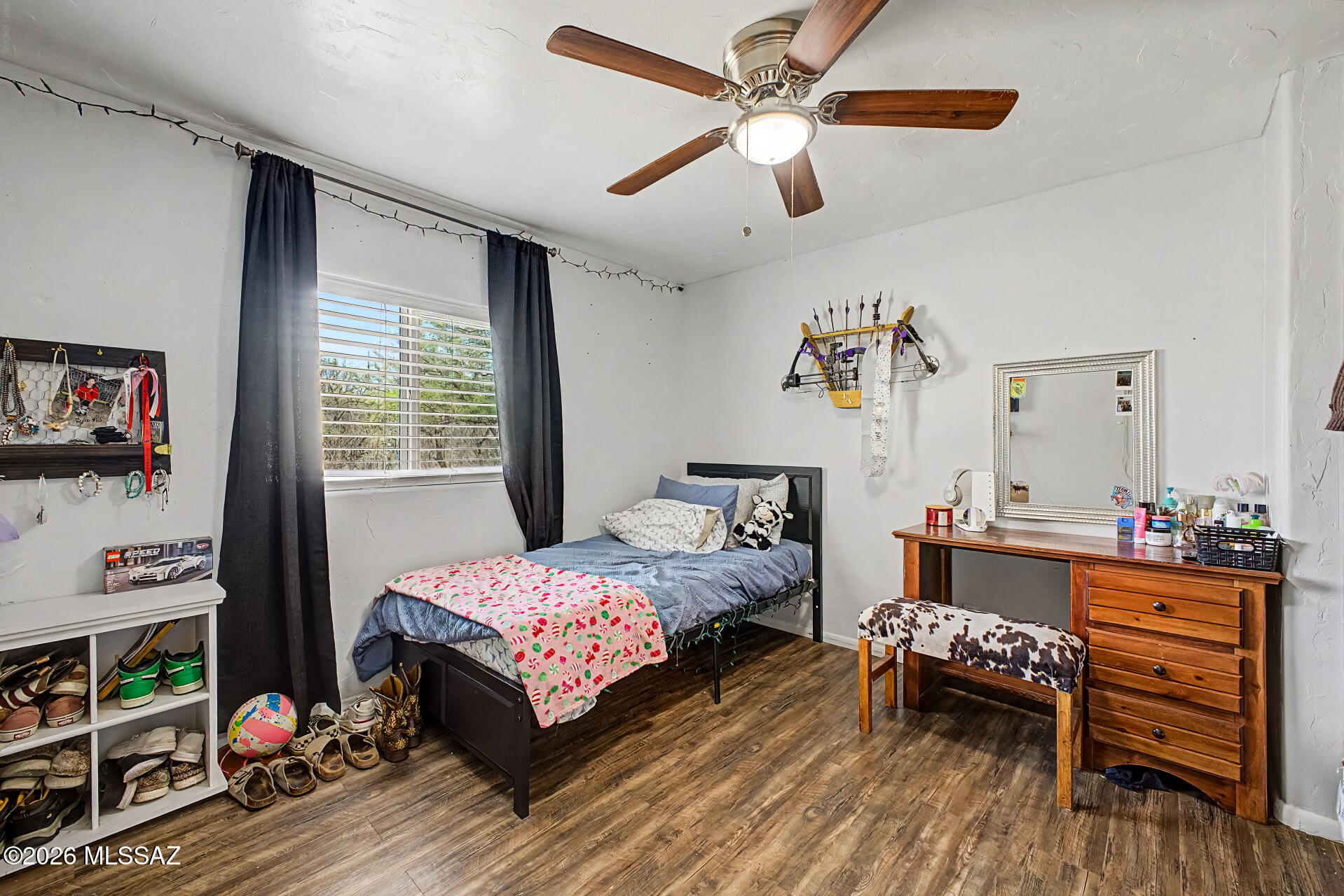 4231 East Pinal Street Tucson, AZ 85739 - Photo 14 of 36 a bedroom with a bed and a wooden floor
