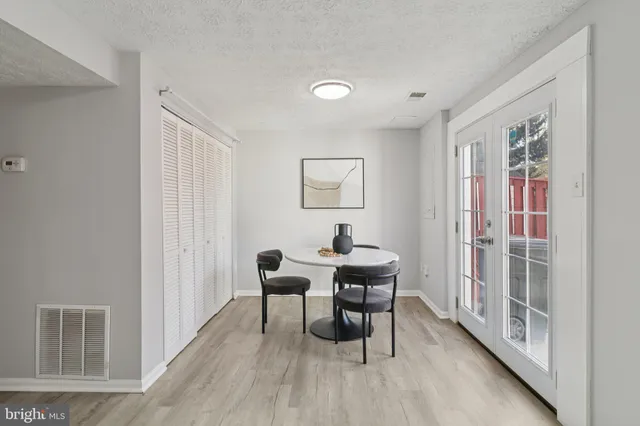 a view of a room with furniture and wooden floor