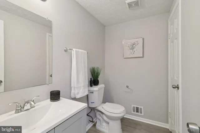 a bathroom with a sink toilet and a mirror