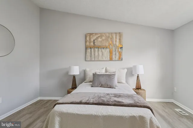 a bedroom with a toilet and white wall