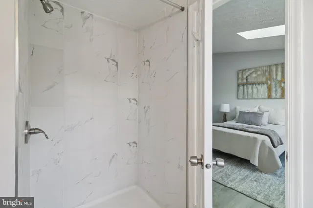 a en suite bathroom with a granite countertop sink