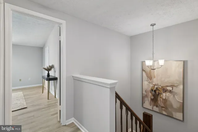 a view of a hallway to a livingroom and a hallway