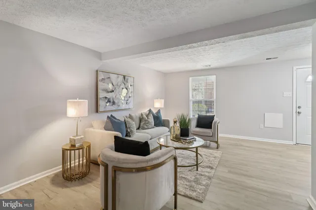 a living room with furniture a lamp and a window