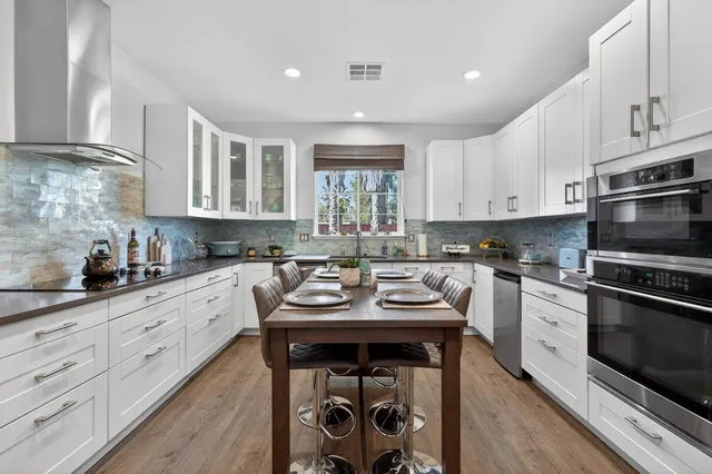 a living room with furniture a rug and a fireplace