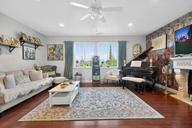 a living room with lots of furniture and a view of kitchen