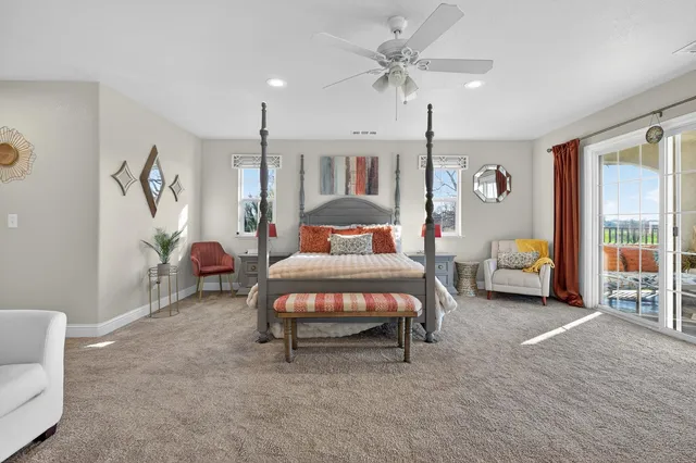 a bedroom with two beds and painting on the wall