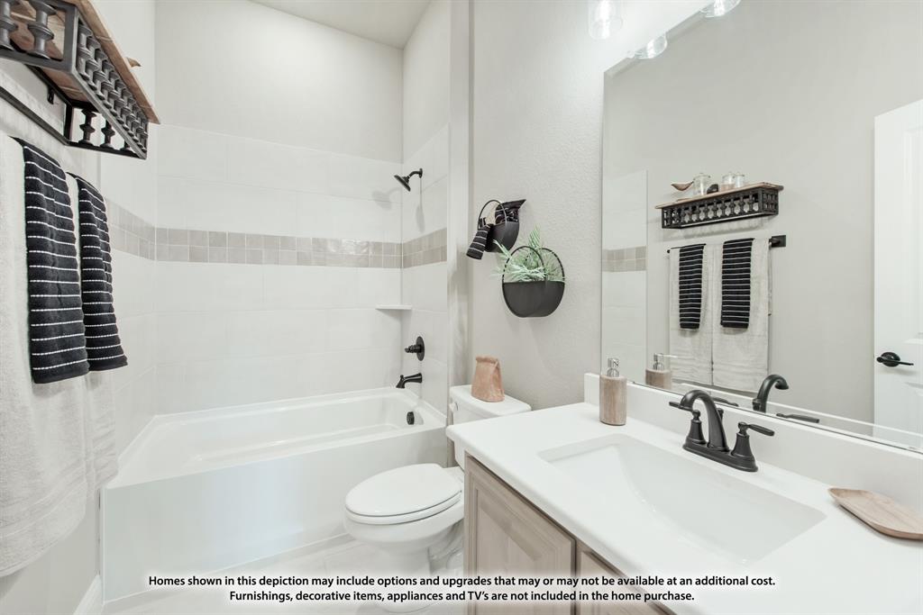 14429 Lovelace Street Pilot Point, TX 76258 - Photo 12 of 36 a bathroom with a toilet a sink and bathtub