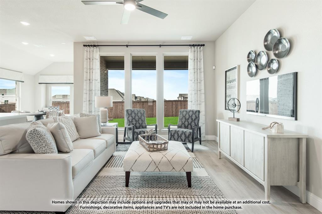 14429 Lovelace Street Pilot Point, TX 76258 - Photo 14 of 36 a living room with furniture a large window and a chandelier