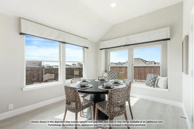 a dining room with furniture large windows and a rug