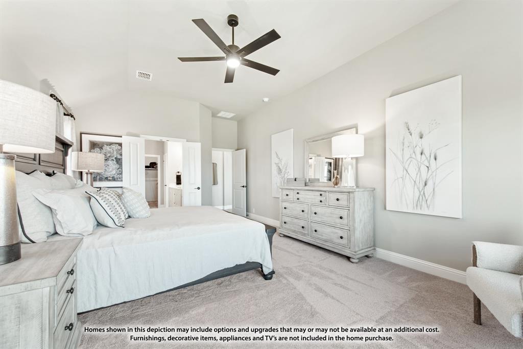 14429 Lovelace Street Pilot Point, TX 76258 - Photo 32 of 36 a bedroom with a large bed and a chandelier