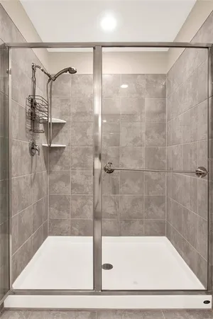 a bathroom with a shower and a sink