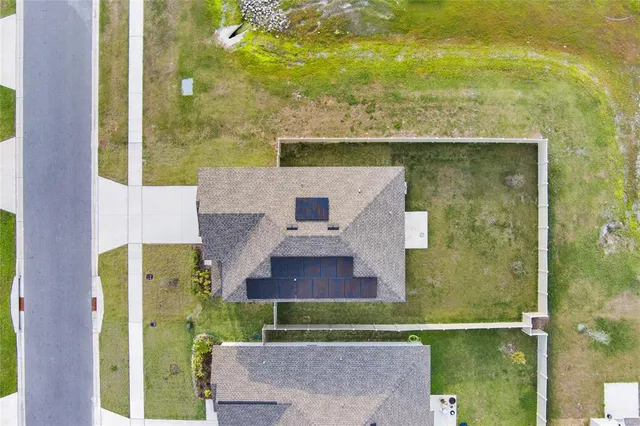 an aerial view of residential houses with outdoor space and swimming pool