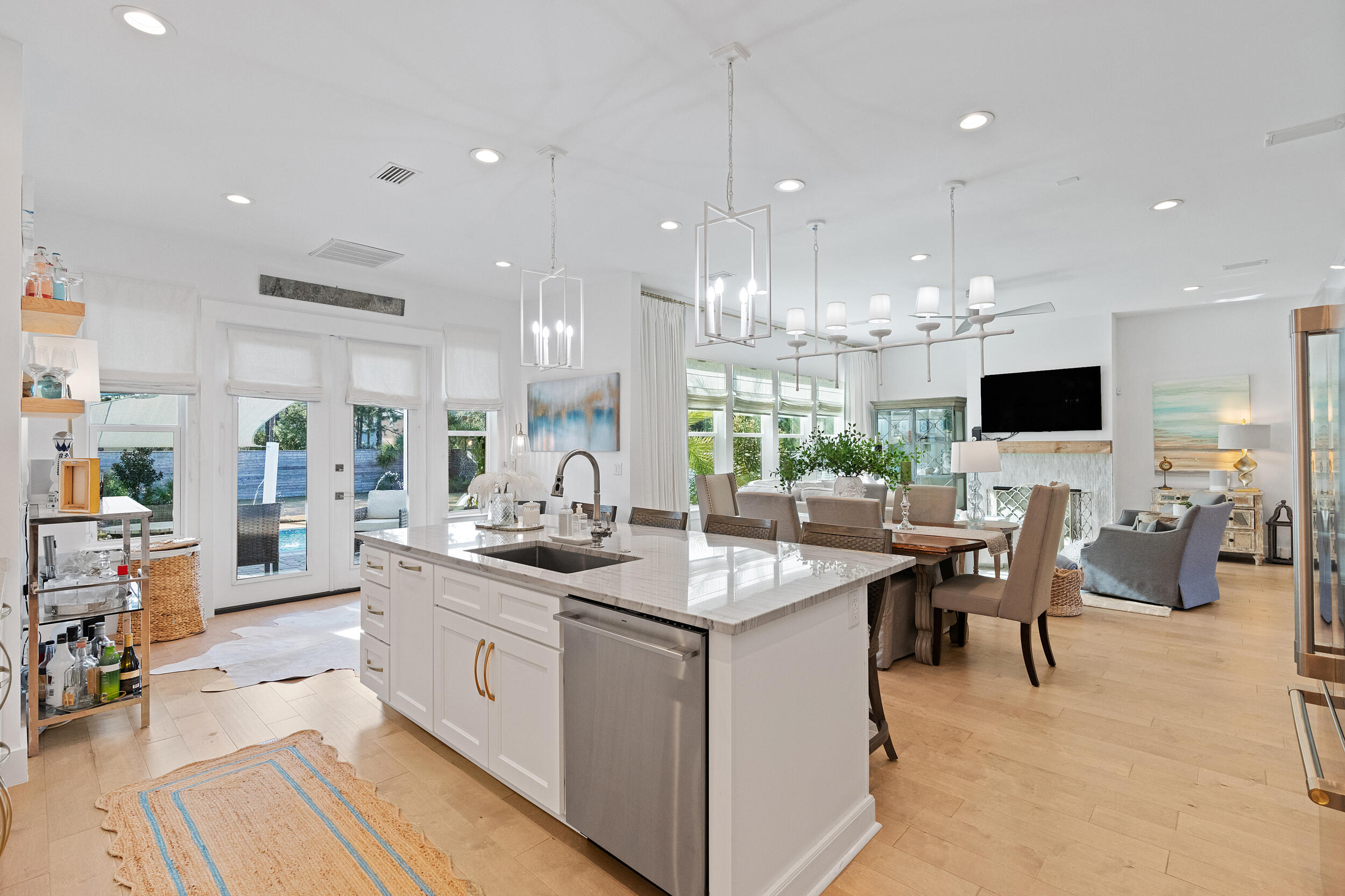 1478 Driftwood Point Road Santa Rosa Beach, FL 32459 - Photo 23 of 95 a kitchen with stainless steel appliances kitchen island granite countertop a sink and a stove top oven with wooden floor