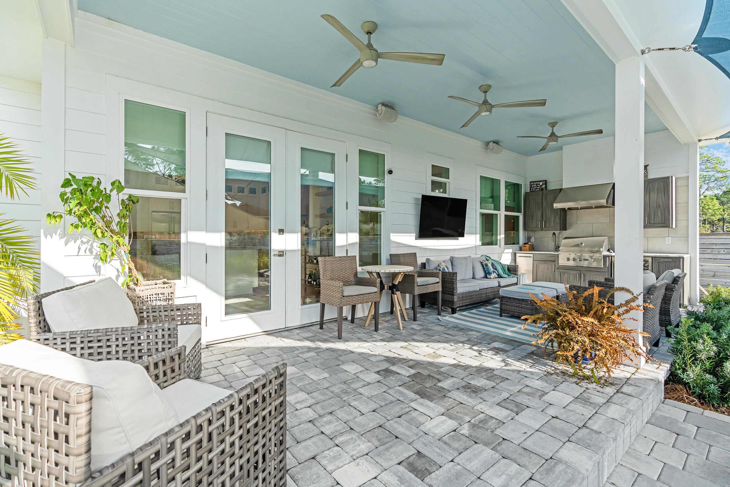 1478 Driftwood Point Road Santa Rosa Beach, FL 32459 - Photo 55 of 95 a living room with patio furniture and a flat screen tv