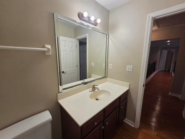 a bathroom with a sink a mirror and a toilet