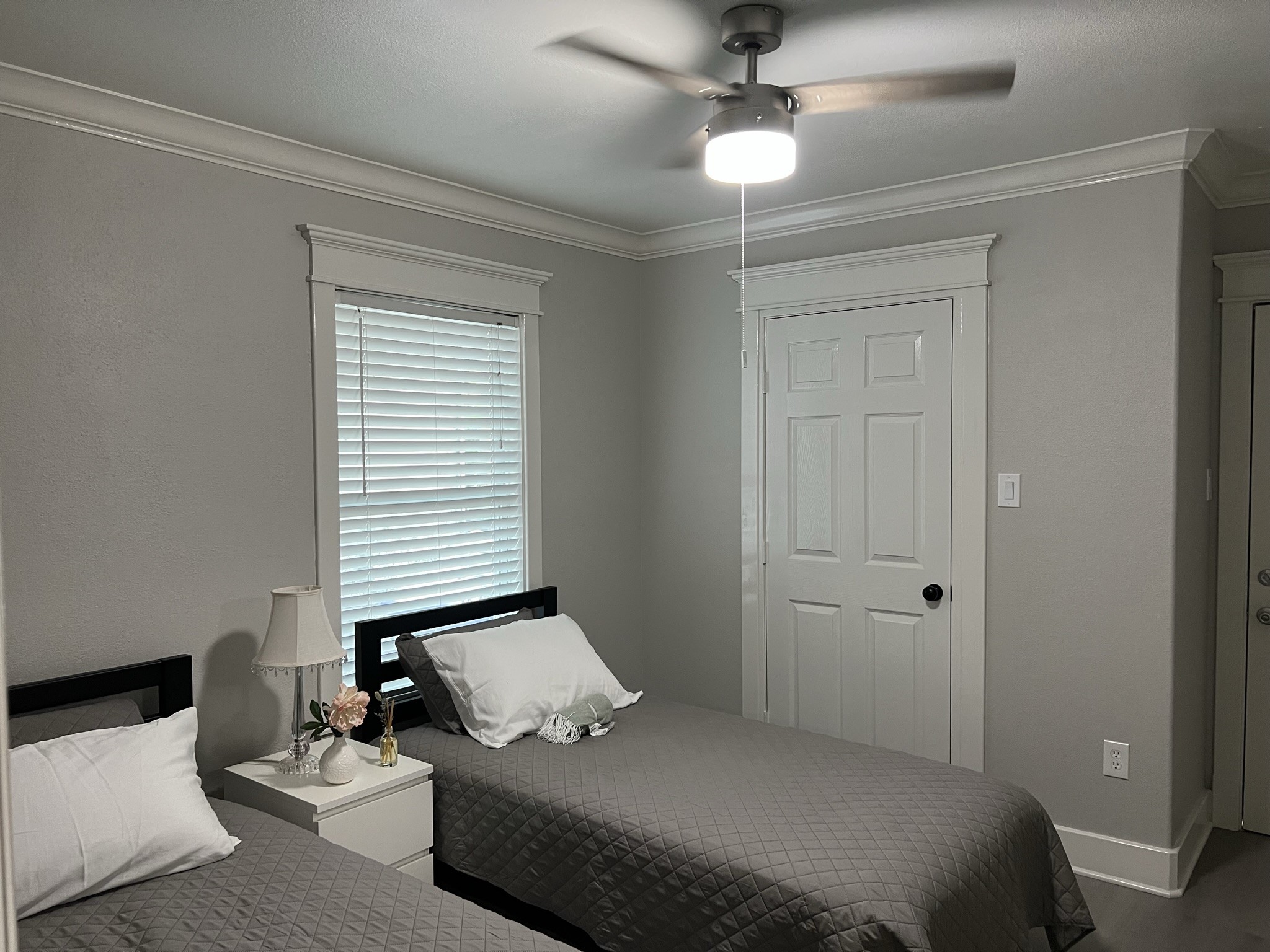 220 Redan Street, Unit A Houston, TX 77009 - Photo 22 of 22 a bedroom with a bed and a chandelier