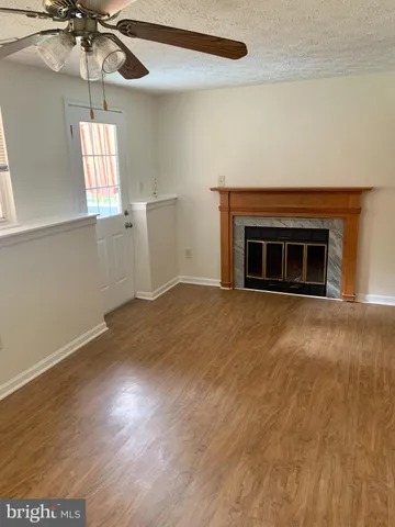 an empty room with windows and fireplace