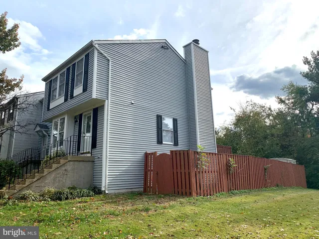 a front view of house with yard and trees