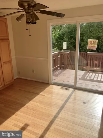 a view of a room with wooden floor and windows
