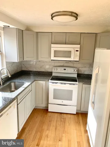 a kitchen with stainless steel appliances granite countertop a stove and a sink