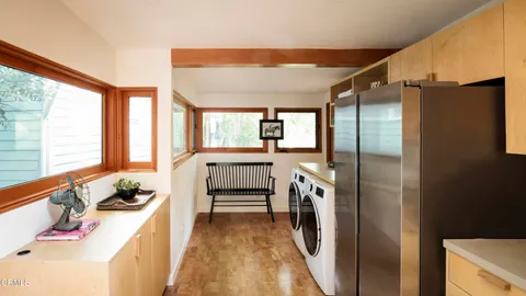 a open kitchen with stainless steel appliances granite countertop a refrigerator a stove and a sink with granite countertops