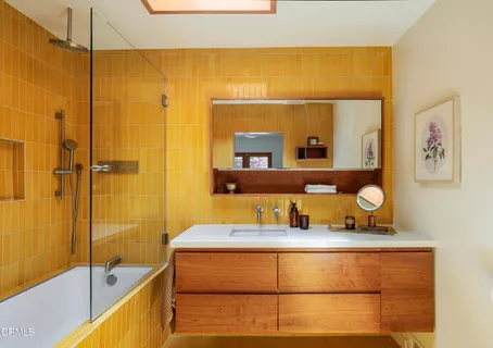 a bedroom with a bed a window and dresser