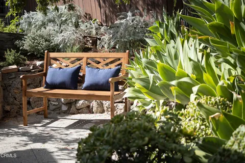 a view of balcony with wooden floor and outdoor seating
